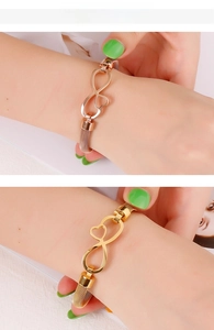 Bracciale a maglia metallica con motivo infinito e cuore in oro e oro rosa