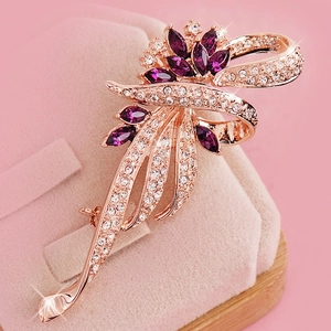 Elegant rose gold flower brooch with purple crystals and white diamonds on velvet