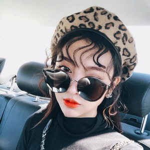 Fashionable leopard print beret for women paired with chic sunglasses and winter outfit