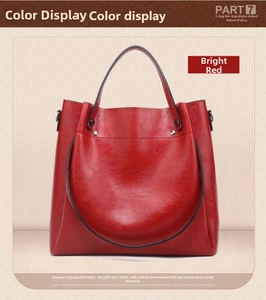 Detailed view of large red tote bag featuring premium lychee pattern leather texture
