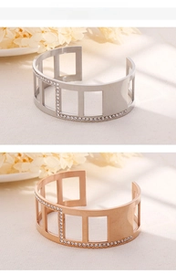 Detail of silver and rose gold striped metal bangles featuring geometric cutouts and rhinestones