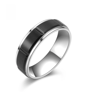 Detail of silver stainless steel ring with black inlay and brushed industrial texture