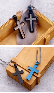 Detail of cross pendants in black and blue finishes with stainless steel bead chains