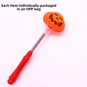 Detail view of Halloween pumpkin glow stick toy with orange spring and red handle