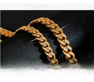 Detail of 10mm and 12mm gold Cuban link chains with white zircon pavé setting