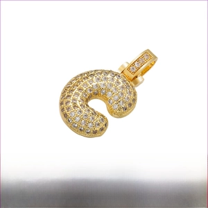 Detail view of gold-plated brass U-shaped pendant with cubic zirconia, size 20x29mm