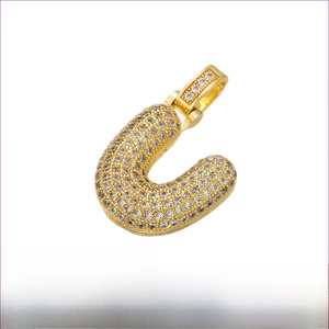 Detailed view of iced out gold letter U pendant with dimensions 20mm by 29mm