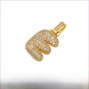 Detailed view of capital letter E pendant in gold brass with micro-paved zircons