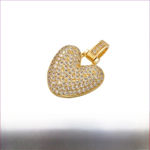 Detailed view of a gold plated brass heart pendant with pave set sparkling white zircons