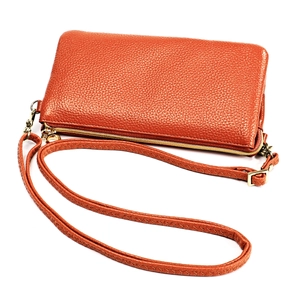 Detail of orange lychee grain leather crossbody bag with golden hardware and strap