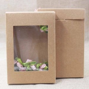 Detail of kraft paper gift boxes with transparent PVC window and decorative pink ribbon