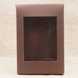 Close-up of a brown kraft paper gift box featuring a clear PVC window and minimalist design