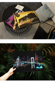 Detail of city night scene scratch art book featuring Louvre and Tokyo landmarks