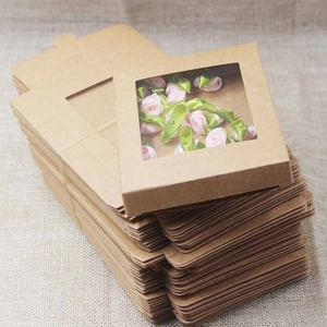 Macro detail of kraft paper box with PVC window and folded flat packaging units