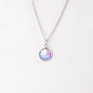 Macro view of 12mm silver stainless steel pendant with purple and pink fish scale pattern