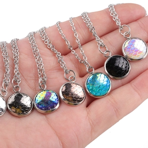 Detailed shot showing seven colorful fish scale texture round pendants on silver chains