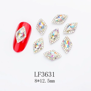 Macro detail of red rhombus nail crystals with alloy base and sparkling rhinestones