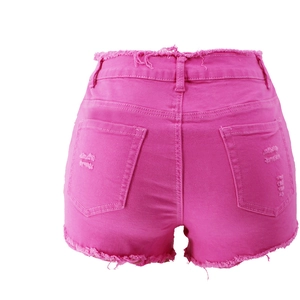 Detail of pink distressed denim shorts featuring frayed edges and functional back pockets