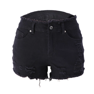 Detailed view of women's black distressed denim shorts with ripped edges and raw hem