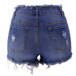 Detail of dark blue denim shorts back with ripped holes and frayed raw hems