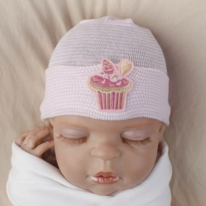 Detail of pink and white striped baby beanie featuring sweet cupcake embroidery