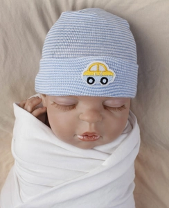 Detail of blue striped newborn knit hat featuring a yellow cartoon car embroidery