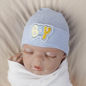 Detail of blue and white striped baby knit hat with yellow Boy embroidery patch
