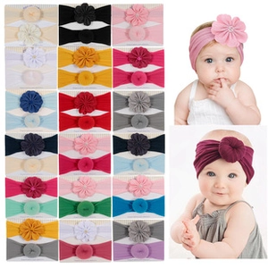 Detail view of infant ribbed headbands with 3D floral and knotted designs in multiple colors