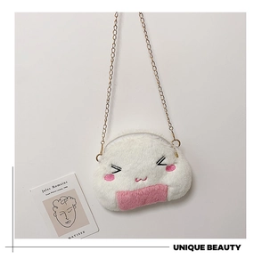 Detail of cute white plush onigiri bag featuring embroidered face and gold chain strap