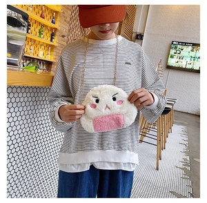 Detail of cute rice ball plush bag featuring facial embroidery and gold chain strap
