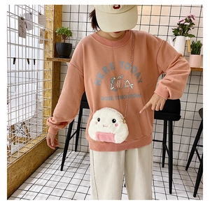 On-body view of a cute plush rice ball crossbody bag with a delicate gold chain strap