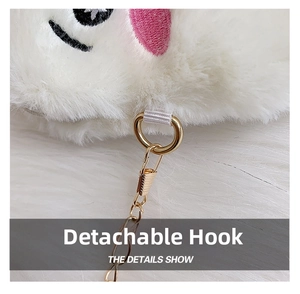 Detail showing the detachable gold lobster clasp and plush white embroidered fabric texture