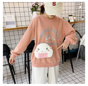 Detailed close-up of a cute white plush rice ball crossbody bag with pink sweatshirt