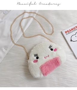 Close-up of cute onigiri plush bag with soft white fur and gold chain strap details