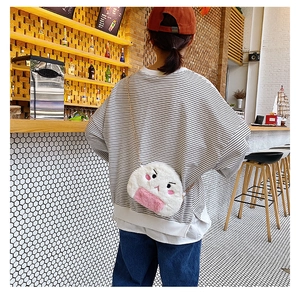 Detailed view of the plush rice ball crossbody bag with cute embroidery and pink trim