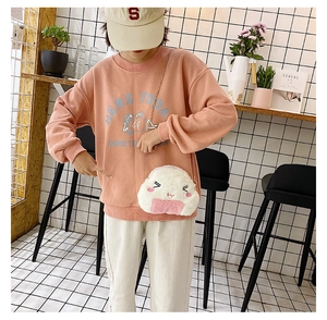 Detail of cute rice ball plush bag with fine embroidery and golden chain strap