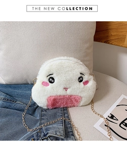 Close-up of plush onigiri bag with embroidery detail and golden chain strap