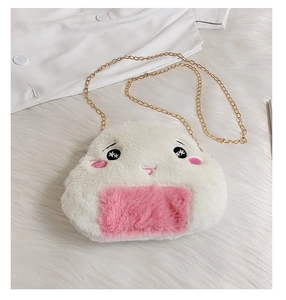 Detail of cute rice ball plush bag with soft fur texture and cartoon face embroidery