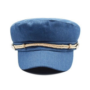Vintage blue corduroy newsboy cap for women featuring brown rope trim and a retro style