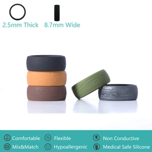 Macro view of 8.7mm wide silicone rings showing detailed wood grain texture and colors