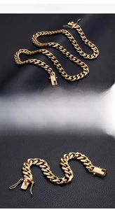 Detail view of 18K gold plated fine steel Cuban chain with secure double-lock clasp