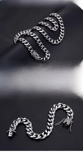 Detail of 13mm silver stainless steel Cuban link chain with iced out rhinestone clasp