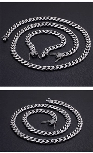 Detailed view of silver Cuban link necklace and bracelet set on dark leather texture