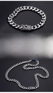 Detail of silver cuban curb chain with CZ zircon stones and secure box clasp closure