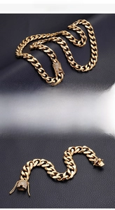 Detail of 18K gold plated Cuban link chain with crystal encrusted clasp on leather