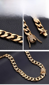 Close-up of 13mm gold Cuban link necklace with rhinestone encrusted box clasp