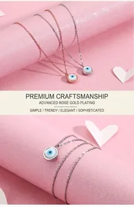 Detailed close-up of Evil Eye teardrop pendants in rose gold and silver finishes