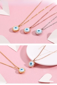 Detail of evil eye pendants in gold, rose gold, and silver finishes with shell inlay