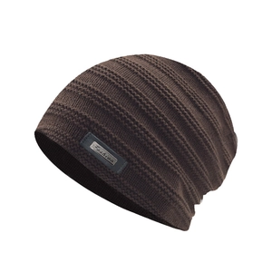 Detail of coffee knit beanie showing thick striped texture and Fashion metal logo label