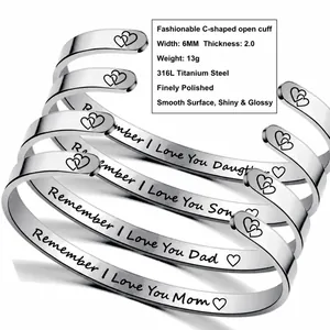 Detailed macro view of four silver 316L stainless steel cuffs with engraved family messages